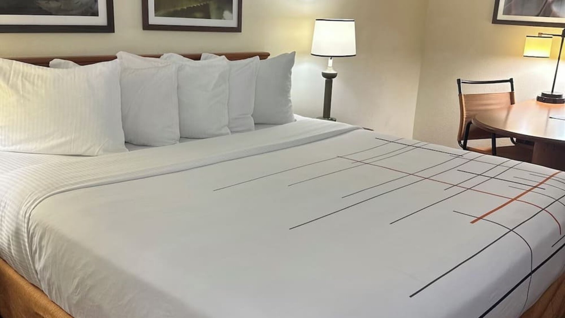 Comfortable guest room featuring a king-size bed, work desk, and modern amenities designed for a restful and productive stay.