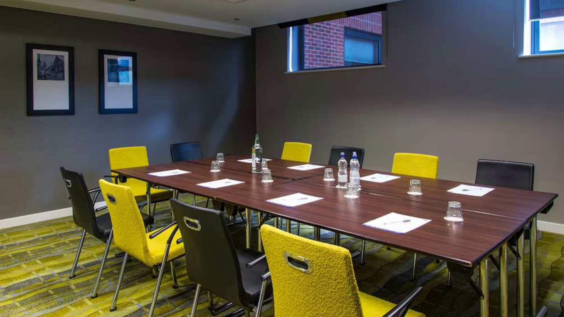 Professional meeting room with plush yellow chairs. 