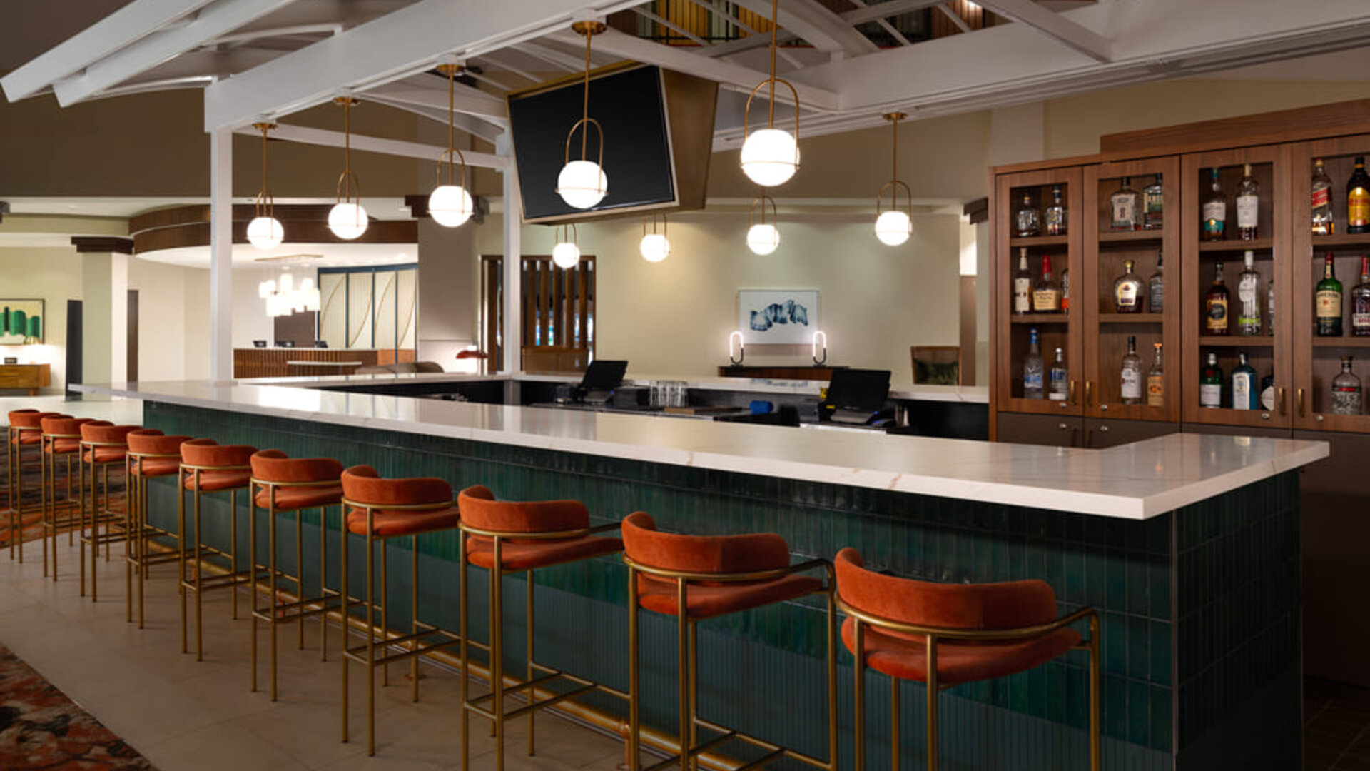 Stylish hotel bar offering comfortable seating, premium beverages, and a contemporary social setting at Embassy Suites By Hilton Charleston Airport Convention Center.