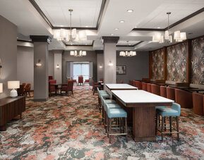 Hotel dining area featuring contemporary seating, open spaces, and a welcoming environment for guests at Embassy Suites By Hilton Charleston Airport Convention Center.