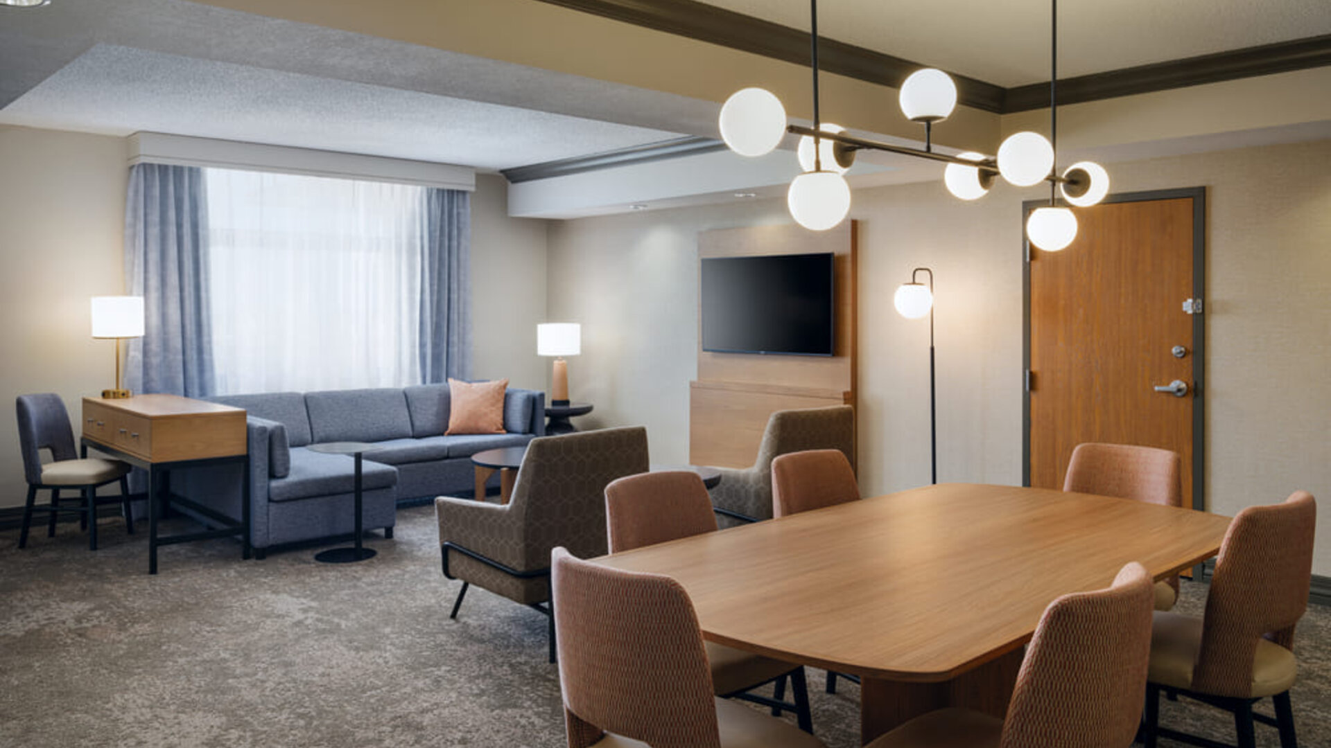 Open seating and lounge space, offering stylish furnishings and a welcoming environment at Embassy Suites By Hilton Charleston Airport Convention Center.