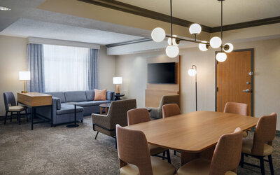 Open seating and lounge space, offering stylish furnishings and a welcoming environment at Embassy Suites By Hilton Charleston Airport Convention Center.
