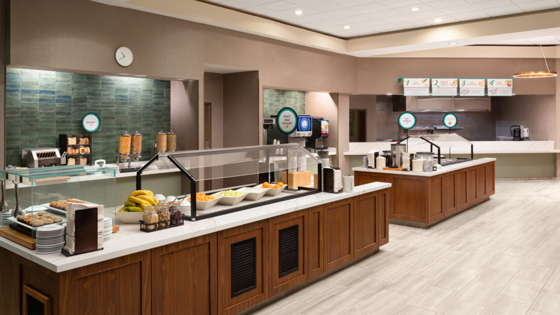 Complimentary breakfast buffet featuring a variety of hot and cold selections, fresh fruit, beverages, and spacious serving stations at Embassy Suites By Hilton Charleston Airport Convention Center.