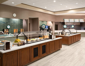 Complimentary breakfast buffet featuring a variety of hot and cold selections, fresh fruit, beverages, and spacious serving stations at Embassy Suites By Hilton Charleston Airport Convention Center.