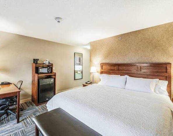 King bedroom with desk at the Hampton Inn Greenfield.
