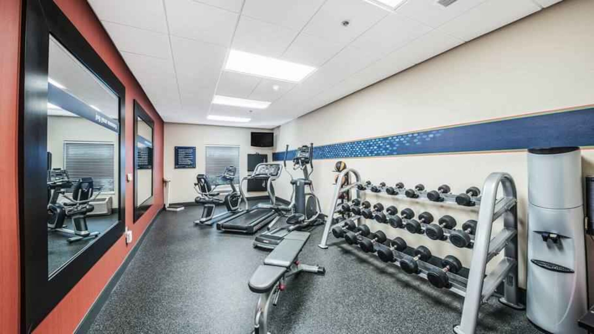 Fitness center with mirror at the Hampton Inn Greenfield.