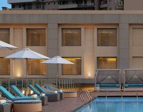 Relaxing outdoor pool area at the DoubleTree by Hilton Agra.