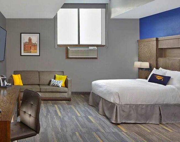 King bedroom with working station at the Tapestry By Hilton Scholar Morgantown, WV.