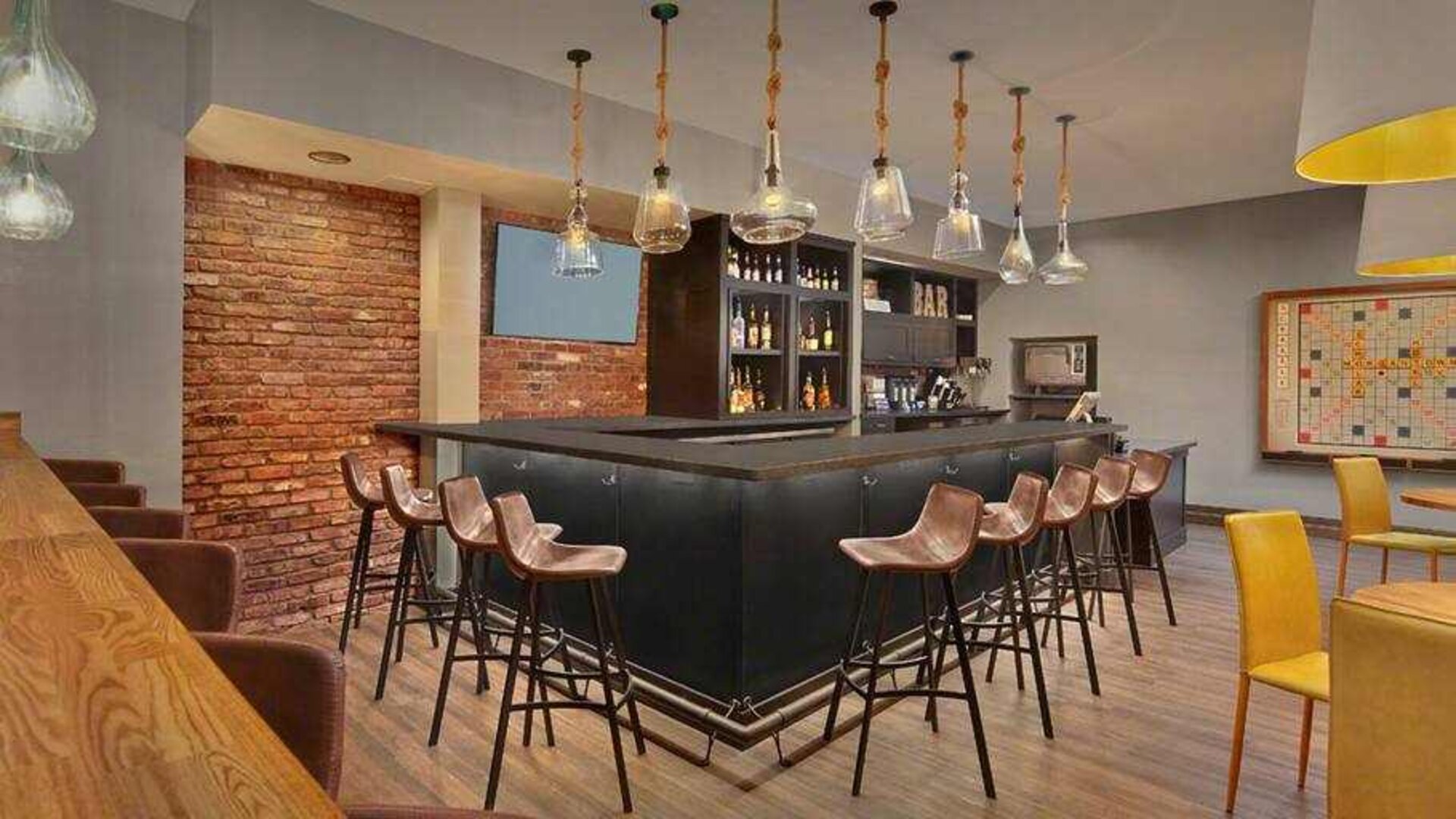 Seating area along the bar at the Tapestry By Hilton Scholar Morgantown, WV.