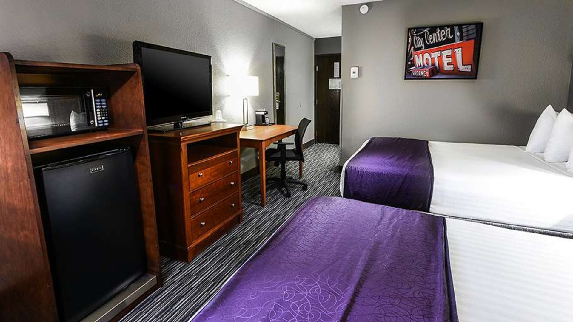 Twin room with TV screen and desk at Best Western McCarran Inn.