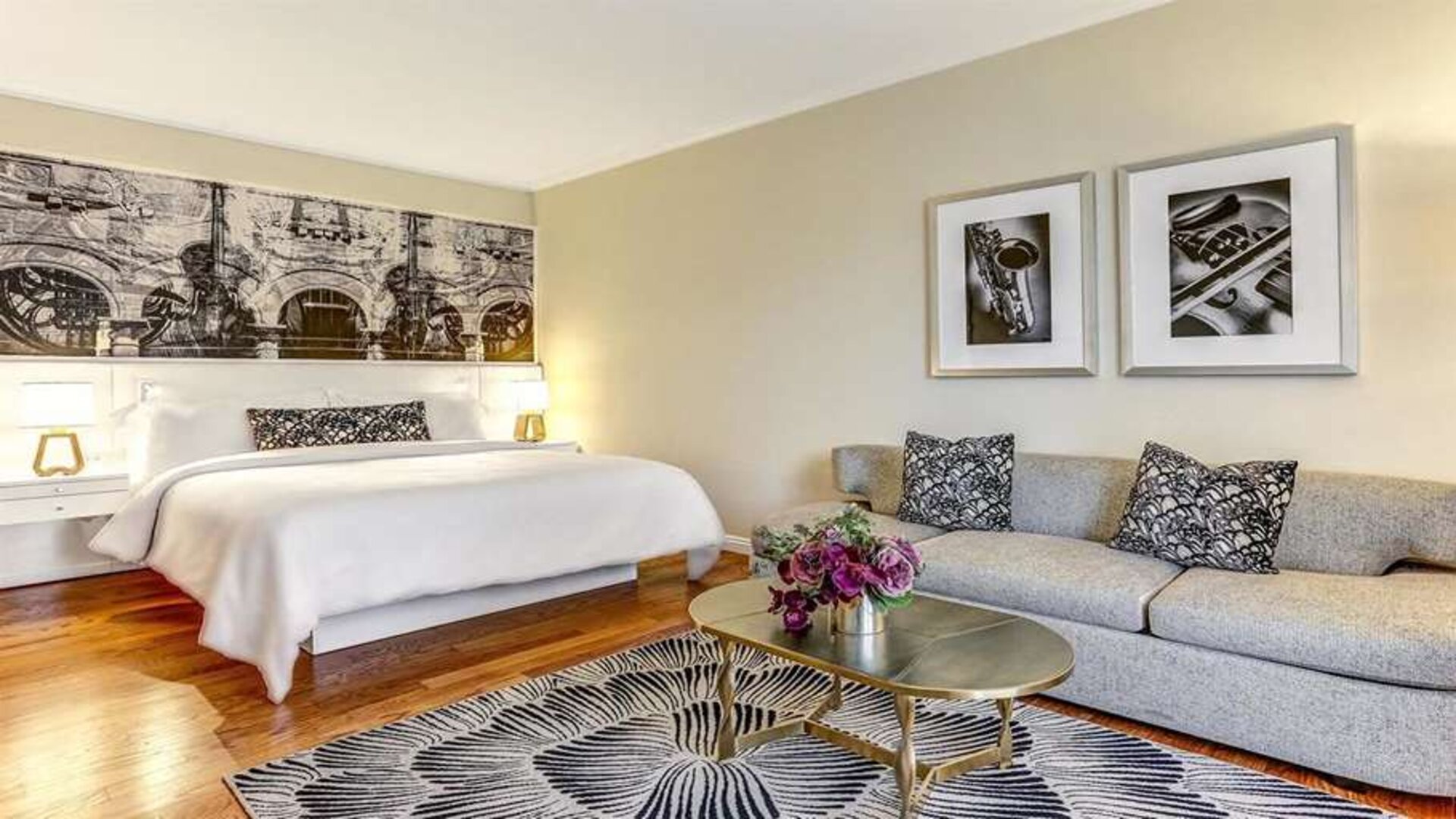 Hotel room with sofa and king bed at Avenue Of The Arts Hotel.