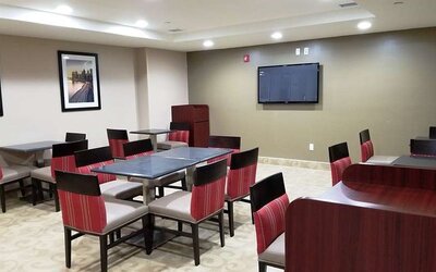 Seating area with TV screen at Days Inn Brooklyn Marine Park.