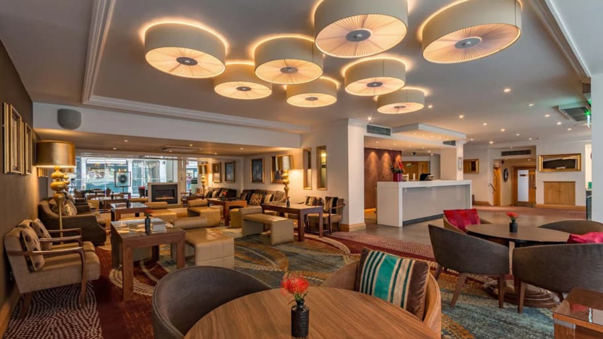 Multi-colored and eclectic chairs and tables fill a spacious lounge area.