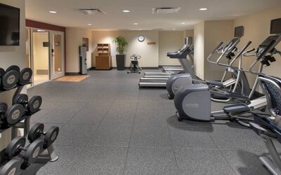 The hotel fitness center, with racks of weights and assorted exercise machinery.