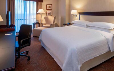 Sheraton Houston Brookhollow Hotel guest room with double bed and a workspace desk and chair.