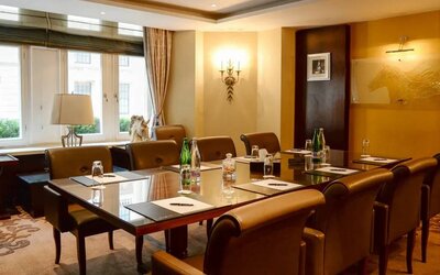 Well-lit boardroom meeting venue with space for around ten people.