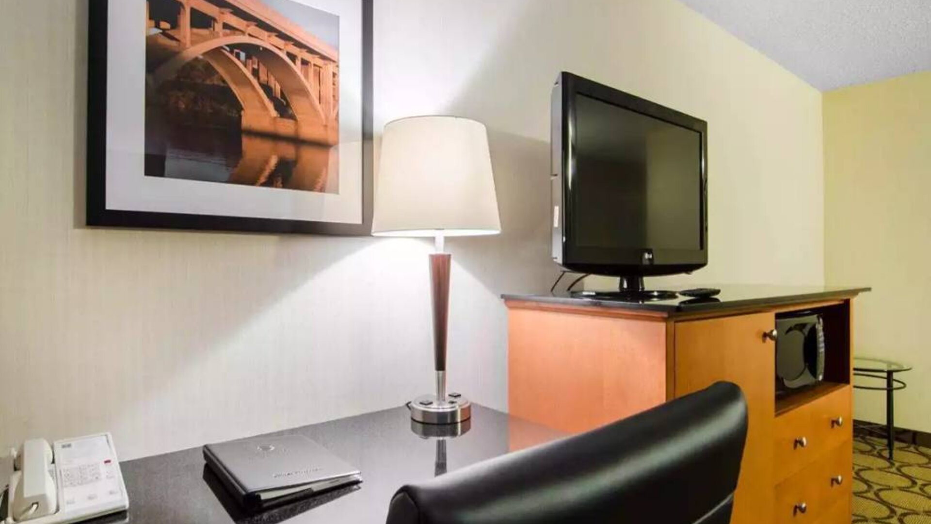 Guest room in the Comfort Inn Saskatoon, with workspace desk and chair and nearby TV.