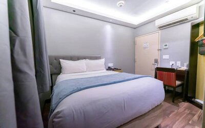 Madison LES Hotel room with double bed, and desk for working.