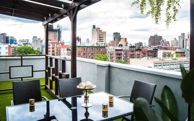 Outdoor terrace with table and chairs for relaxing/socializing.