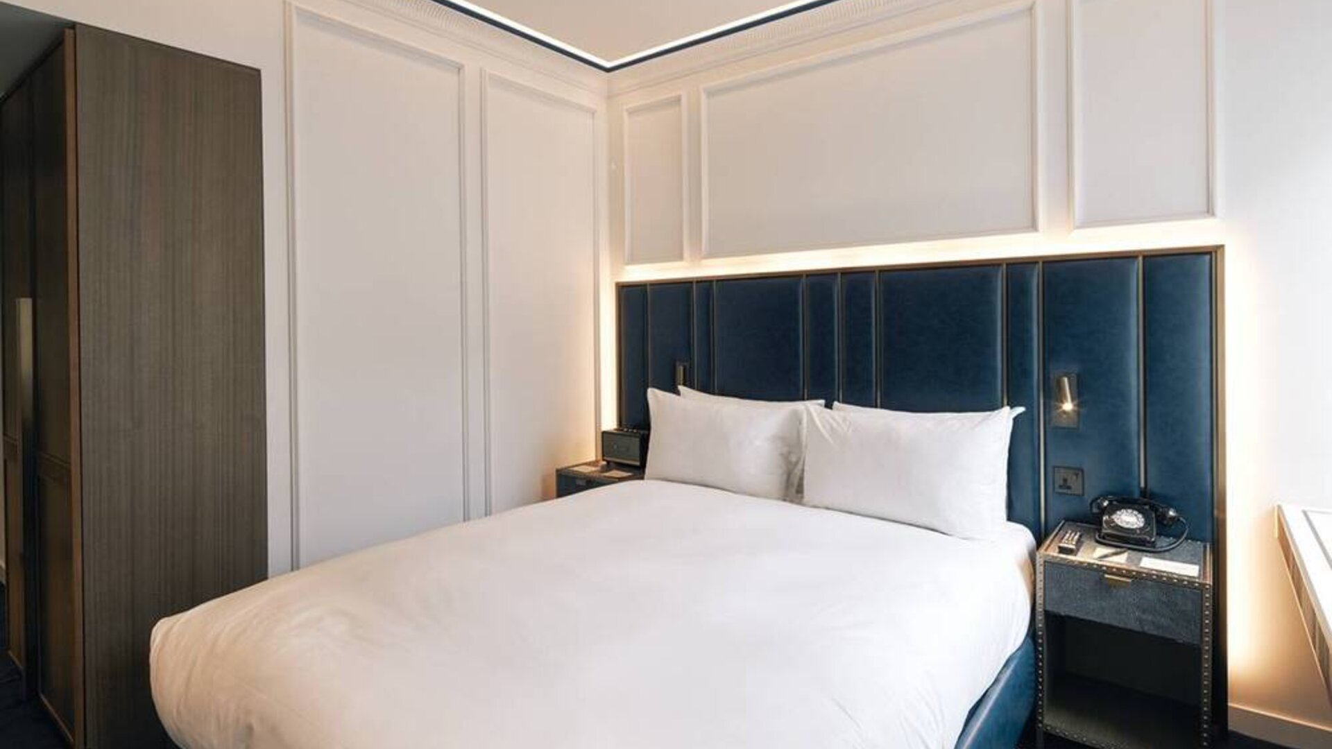 A double bedroom in the Page8, Page Hotels with bedside tables including a charming retro telephone.