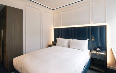 A double bedroom in the Page8, Page Hotels with bedside tables including a charming retro telephone.