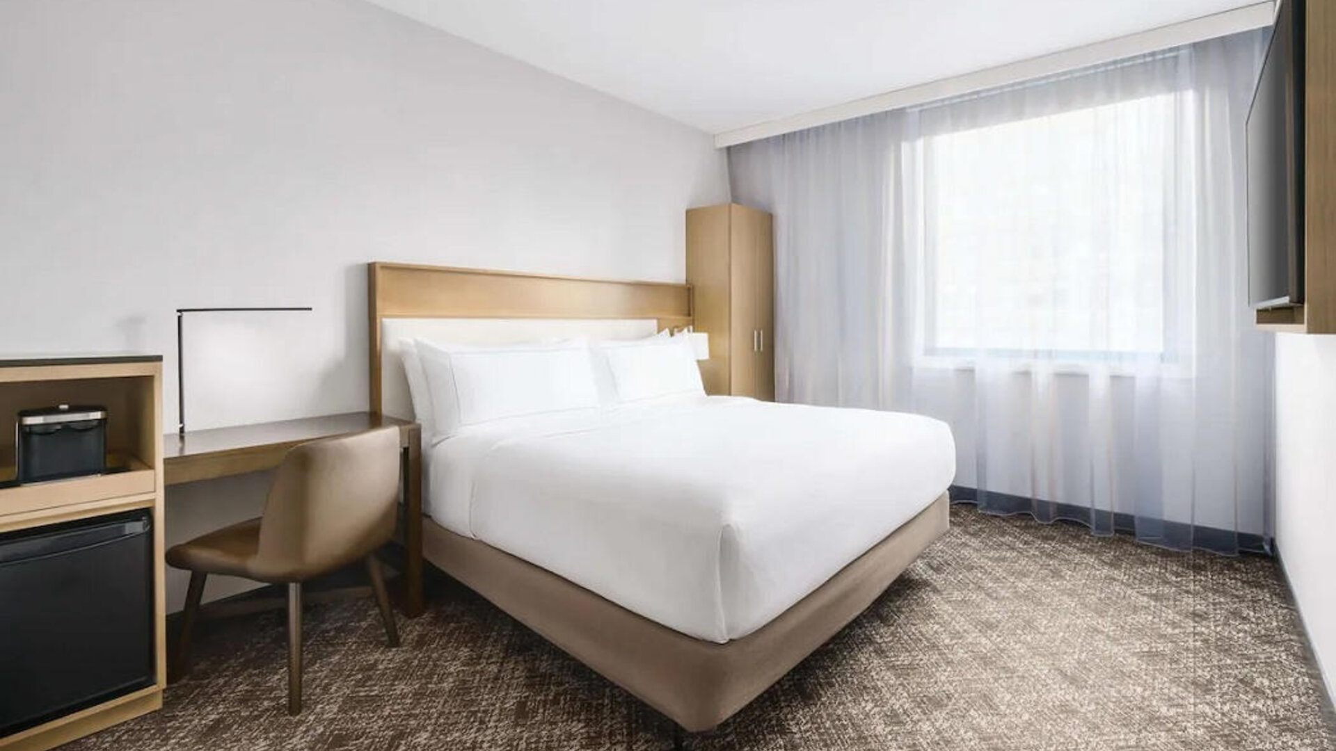 Guest room in the DoubleTree Times Square South, with double bed and workspace desk and chair.