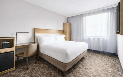 Guest room in the DoubleTree Times Square South, with double bed and workspace desk and chair.