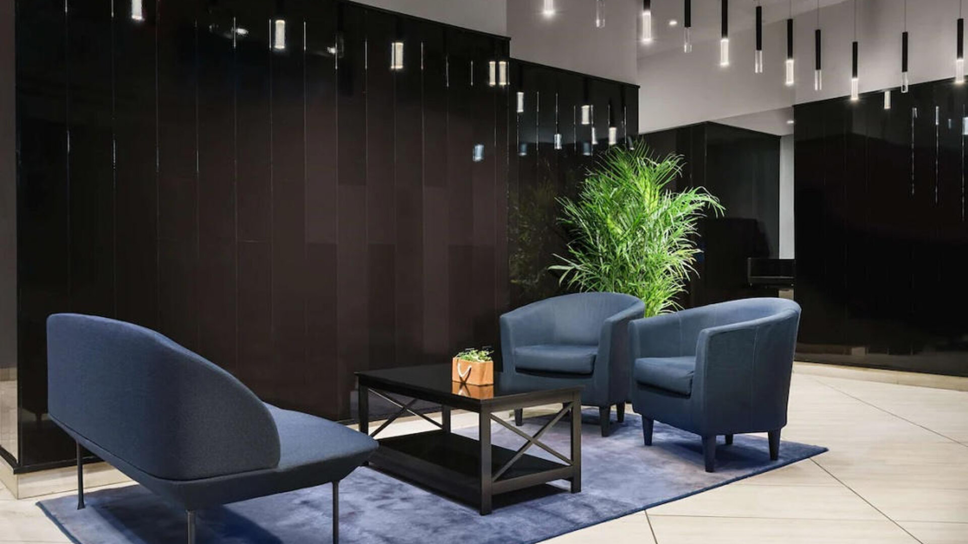 The hotel’s lobby, with comfortable chairs and sofa, plus coffee table.