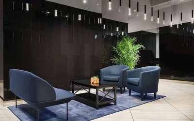 The hotel’s lobby, with comfortable chairs and sofa, plus coffee table.