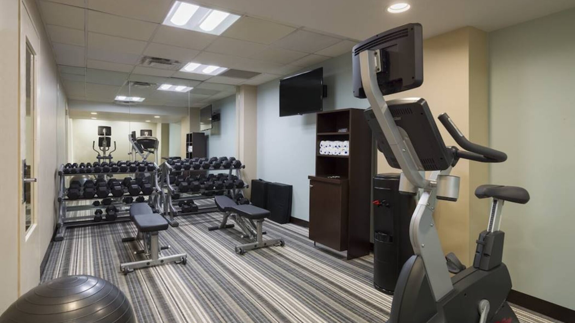 The hotel fitness center, with benches, weights, and various exercise machines.