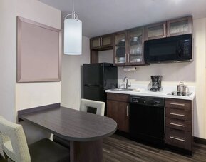 The kitchenette area in a guest room of Candlewood Suites Times Square, including fridge, oven, and microwave.