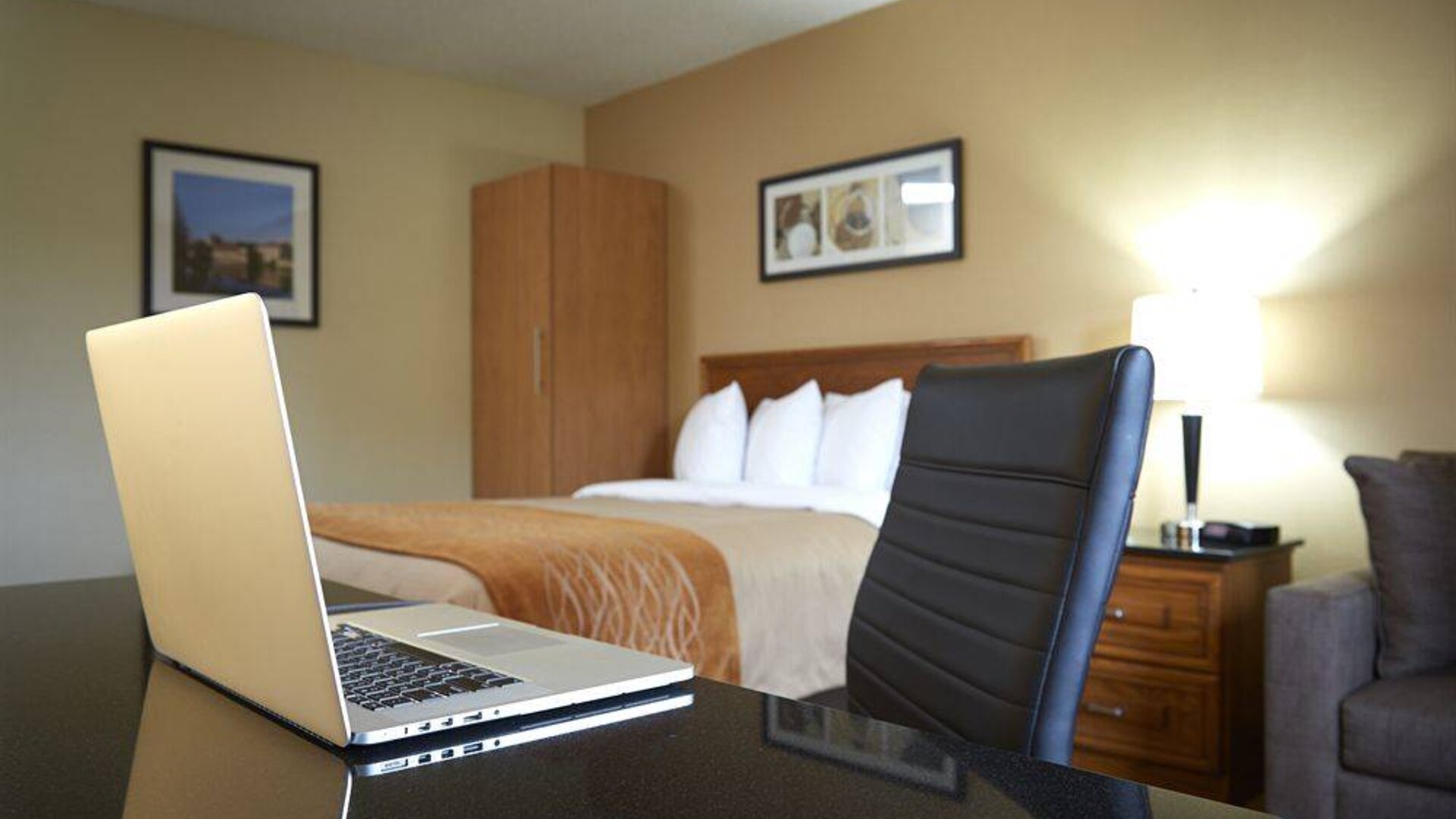 An in-room workspace desk and chair at Comfort Inn Fredericton.