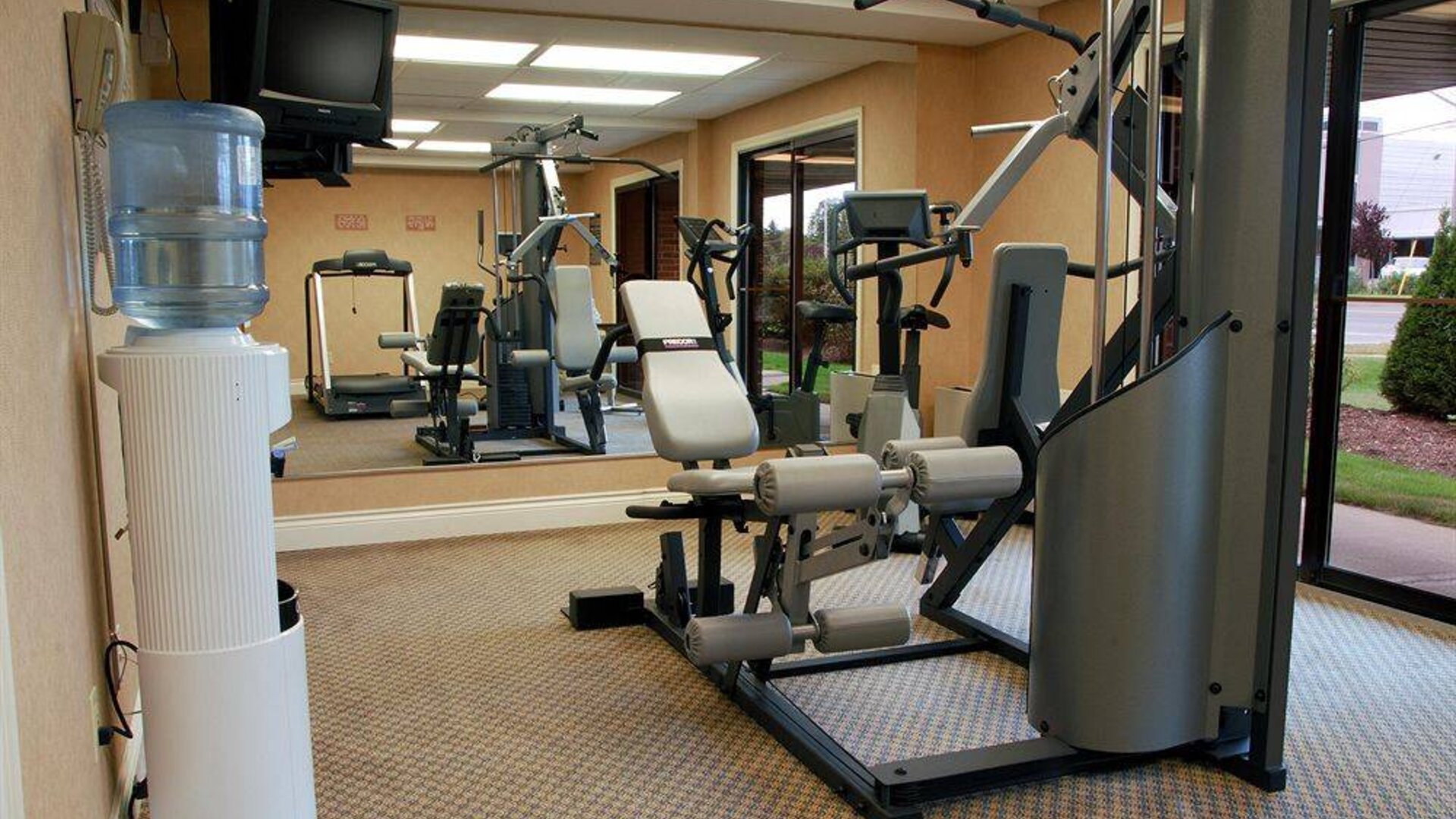 Comfort Inn Fredericton’s fitness center has multiple exercise machines and an overhead TV.
