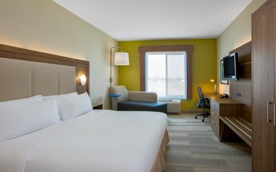 Spacious delux king room with TV and work desk at Holiday Inn Express & Suites Ontario.