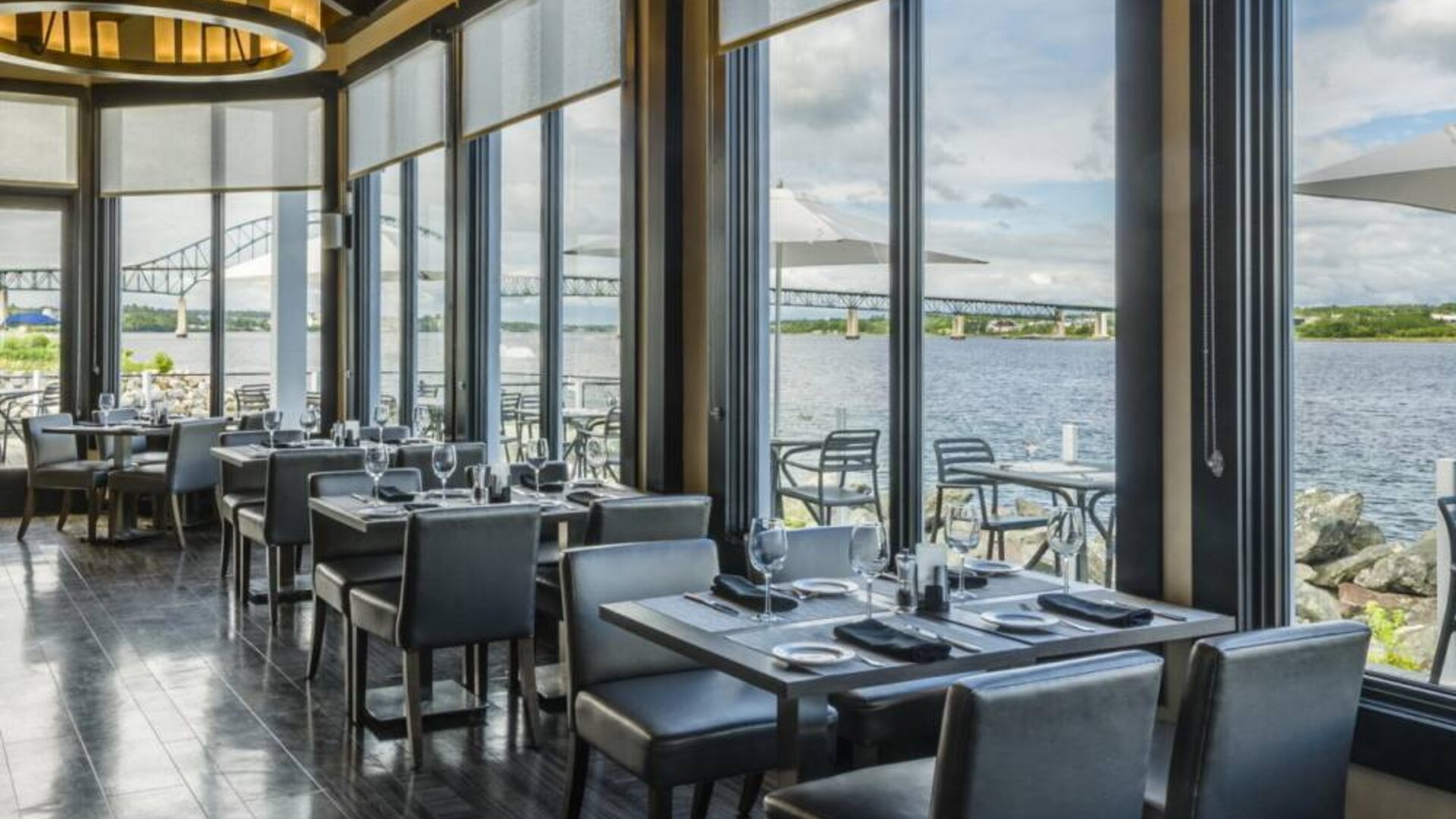 Rodd Miramichi River’s on-site restaurant has hard floors and tables with waterfront views.