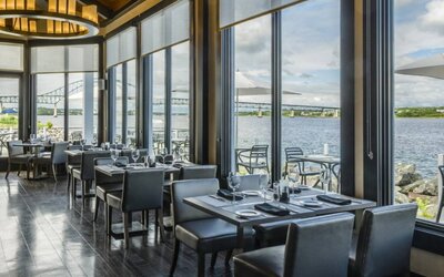 Rodd Miramichi River’s on-site restaurant has hard floors and tables with waterfront views.