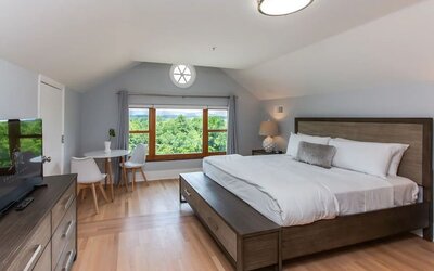 King room with TV and work space at Skylaranna Hotel and Resort.