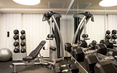 The Hotel 48LEX New York’s fitness center, with weights and exercise machinery.