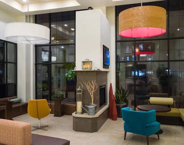 AMTD Idea Tribeca’s lounge, with numerous comfy chairs and sofas, plus small tables.