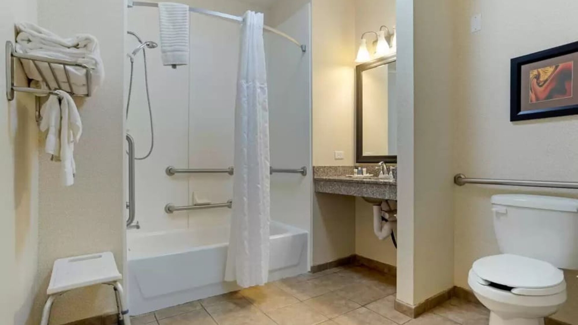 Guest bathroom with bath and shower combo at Comfort Suites Alexandria, LA.