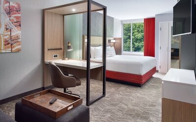 Spacious king room with TV and business desk at SpringHill Suites Atlanta Northwest.
