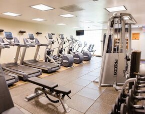 Fitness center with treadmills at Embassy Suites By Hilton West Palm Beach Central.
