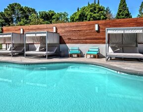 Relaxing pool area with cabanas at Hampton Inn Vallejo.