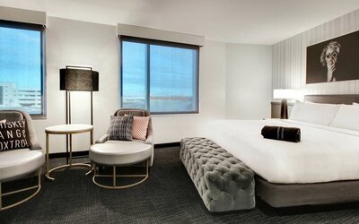 Spacious king bed with natural light at The Rose Hotel Chicago O’Hare, Tapestry Collection By Hilton.