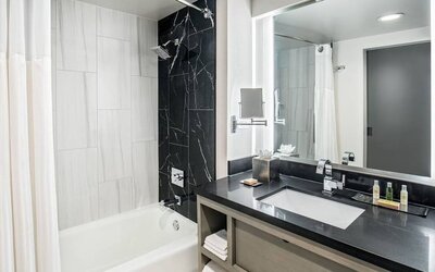Private guest bathroom with shower and tub at DoubleTree By Hilton Washington DC North/Gaithersburg.