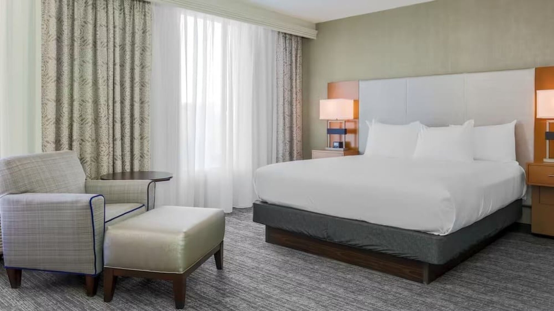 King bed with natural light at DoubleTree Atlanta Airport.