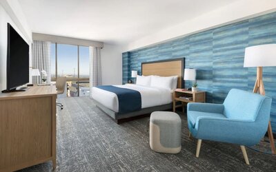 Spacious delux king room with work desk and TV at Hotel Caza.