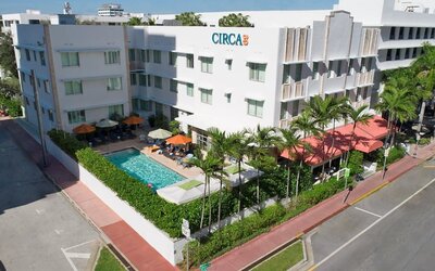 Pool area surrounded by pool chairs and greenery at Circa 39 Hotel.