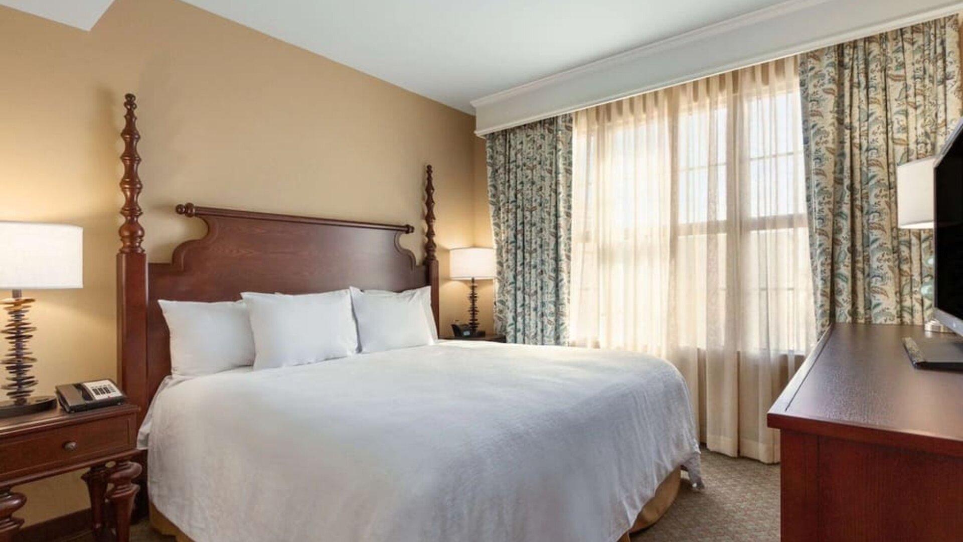 Delux king room with TV at Embassy Suites By Hilton Savannah.