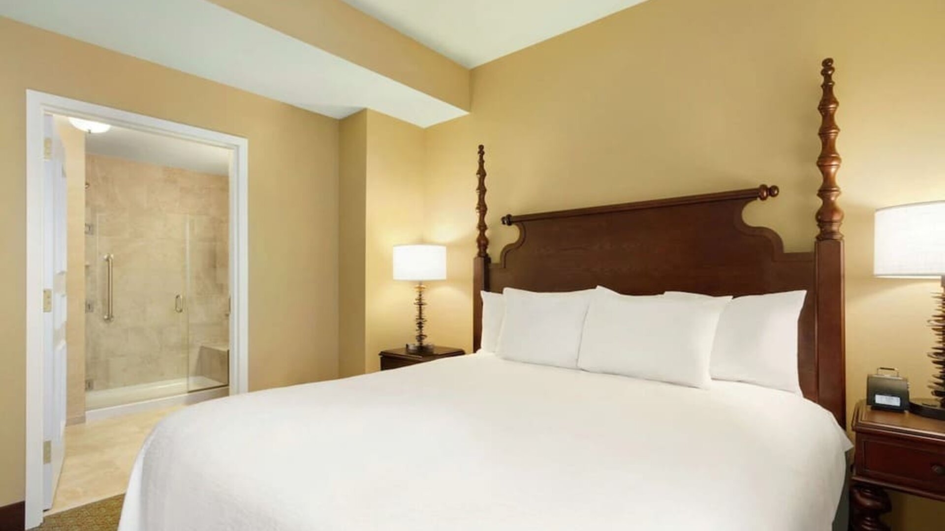 King bedroom with private bathroom at Embassy Suites By Hilton Savannah.